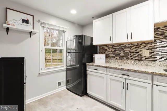 a kitchen with appliances cabinets and a window