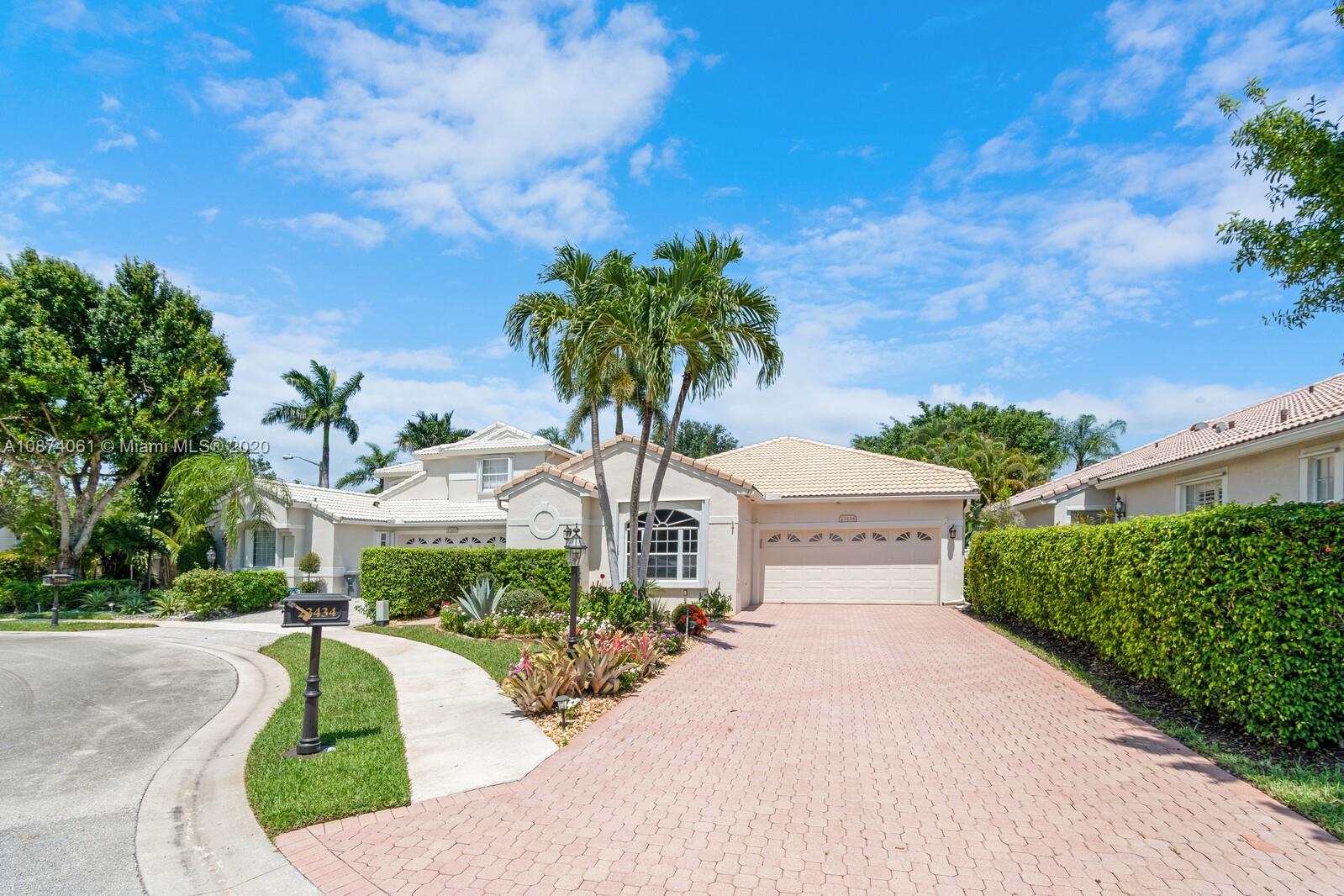 23434 Rakelle Circle Boca Raton, FL 33433 - Photo 2 of 40 a front view of a house with garden