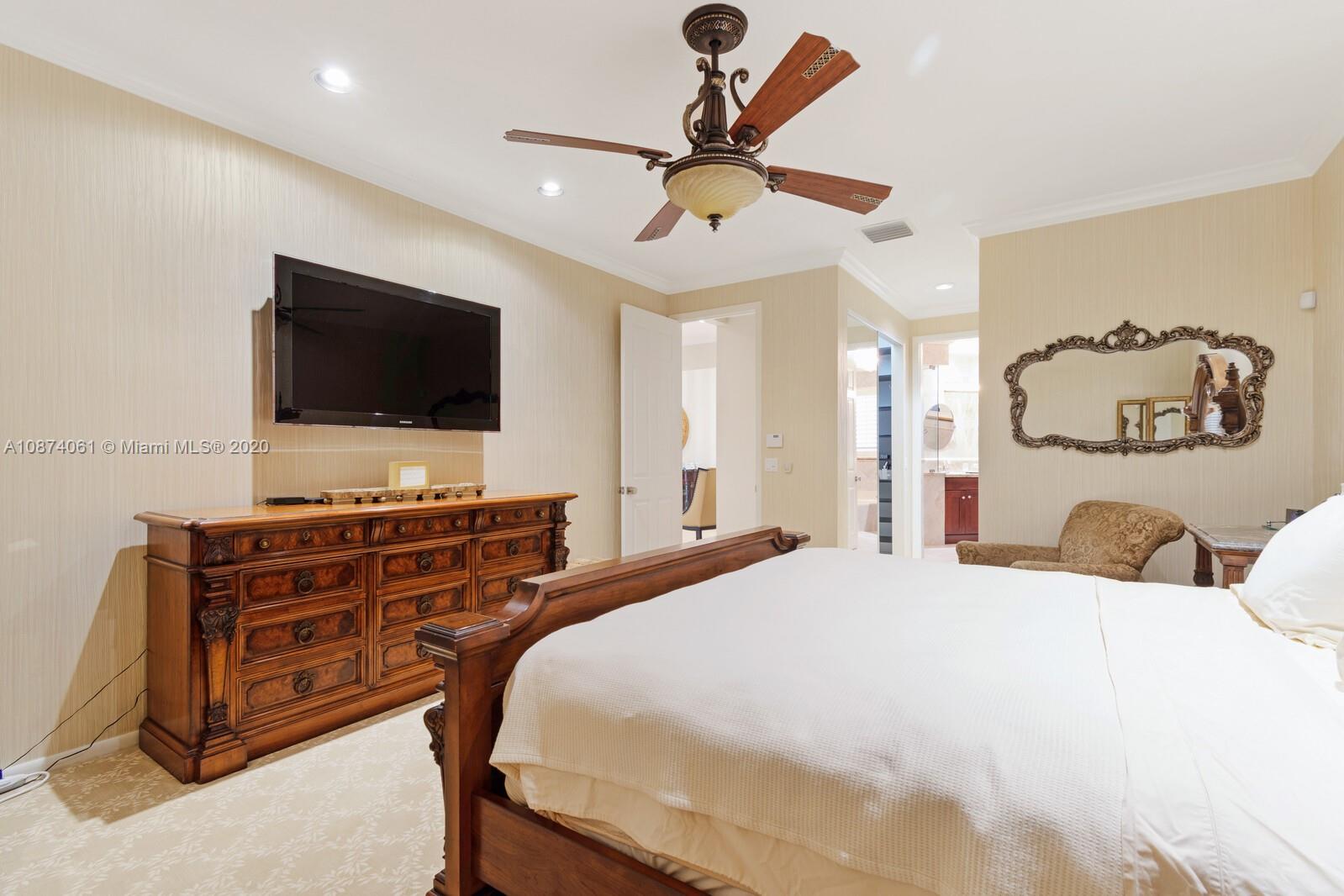 23434 Rakelle Circle Boca Raton, FL 33433 - Photo 23 of 40 a bedroom with a bed and a flat screen tv