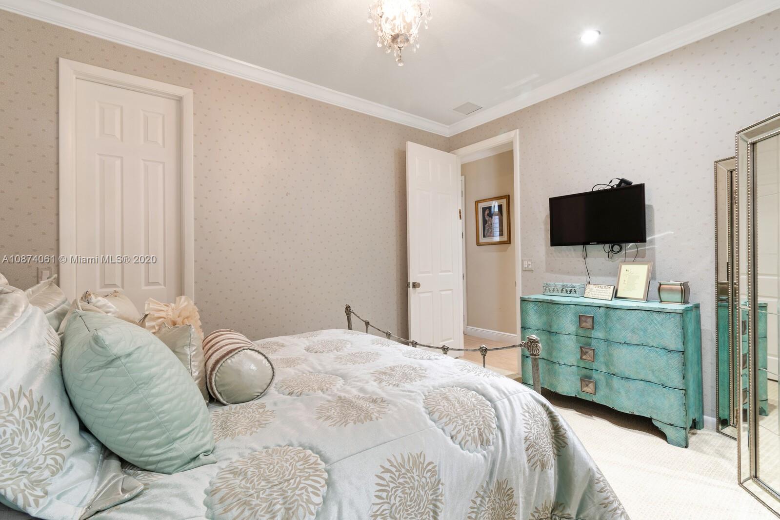 23434 Rakelle Circle Boca Raton, FL 33433 - Photo 27 of 40 a bedroom with a bed and a flat screen tv
