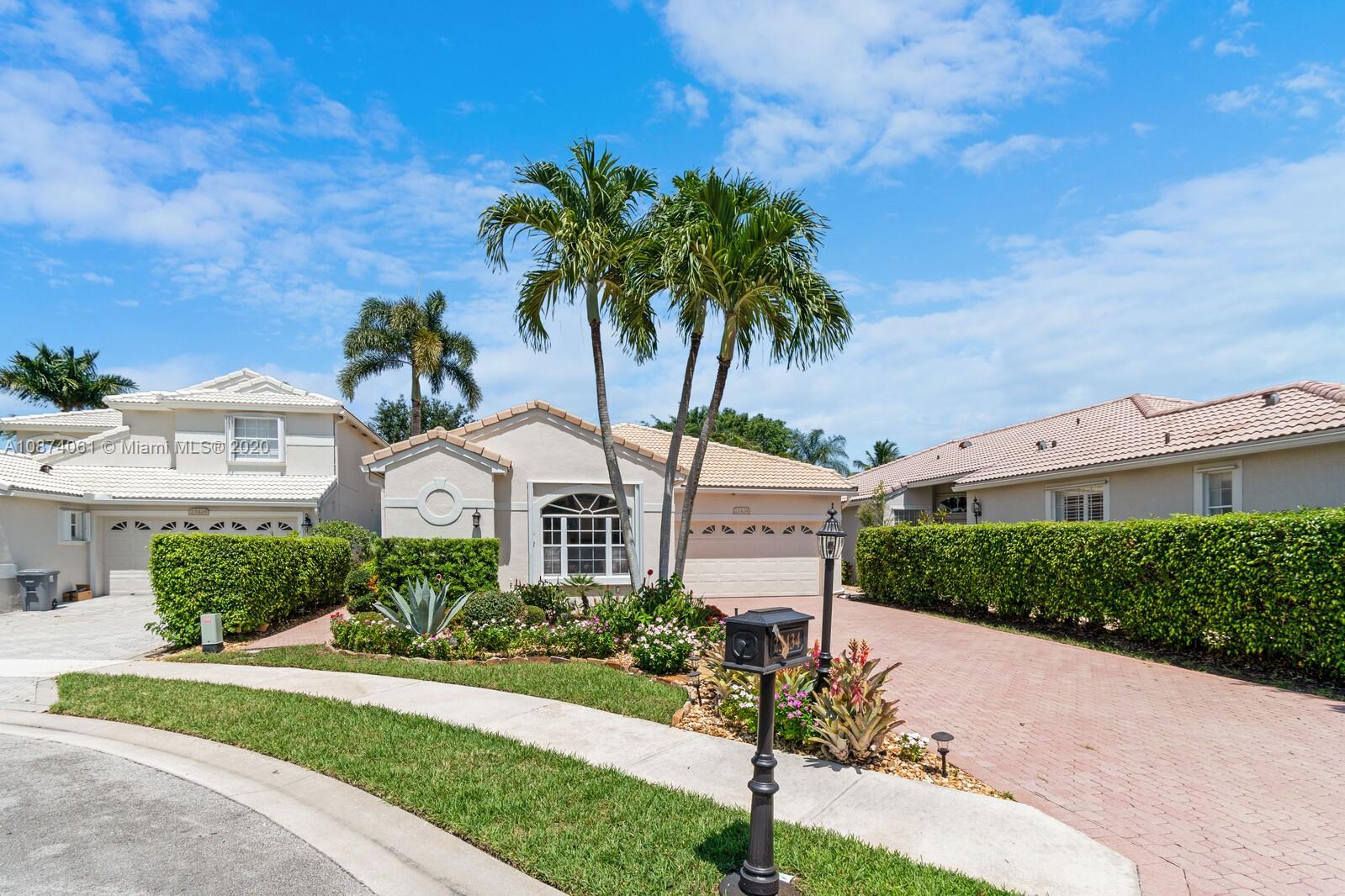 23434 Rakelle Circle Boca Raton, FL 33433 - Photo 38 of 40 a front view of a house with a yard and garage