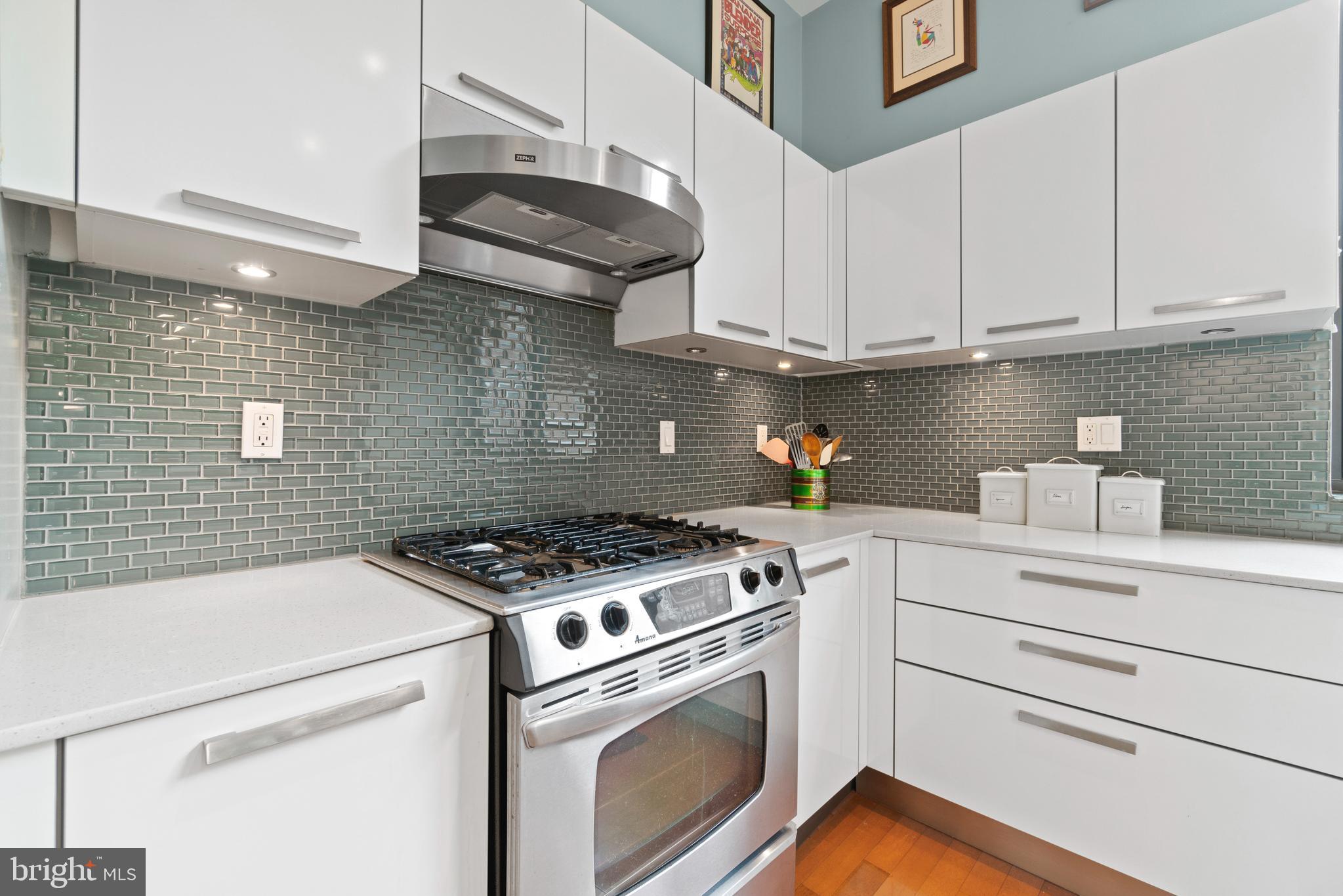 2426 Ontario Road Northwest, Unit 201 Washington, DC 20009 - Photo 7 of 19 a kitchen with stainless steel appliances granite countertop white cabinets a stove a sink and dishwasher