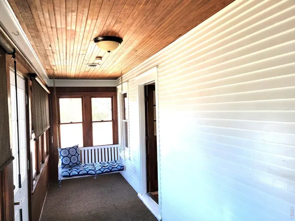 a view of a hallway with a porch