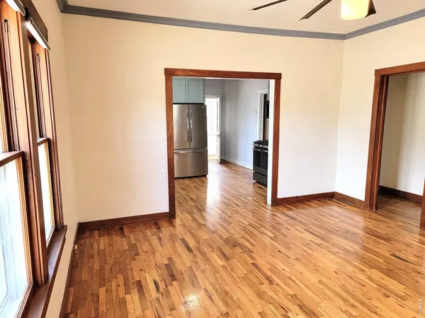 a view of a room with wooden floor and gate