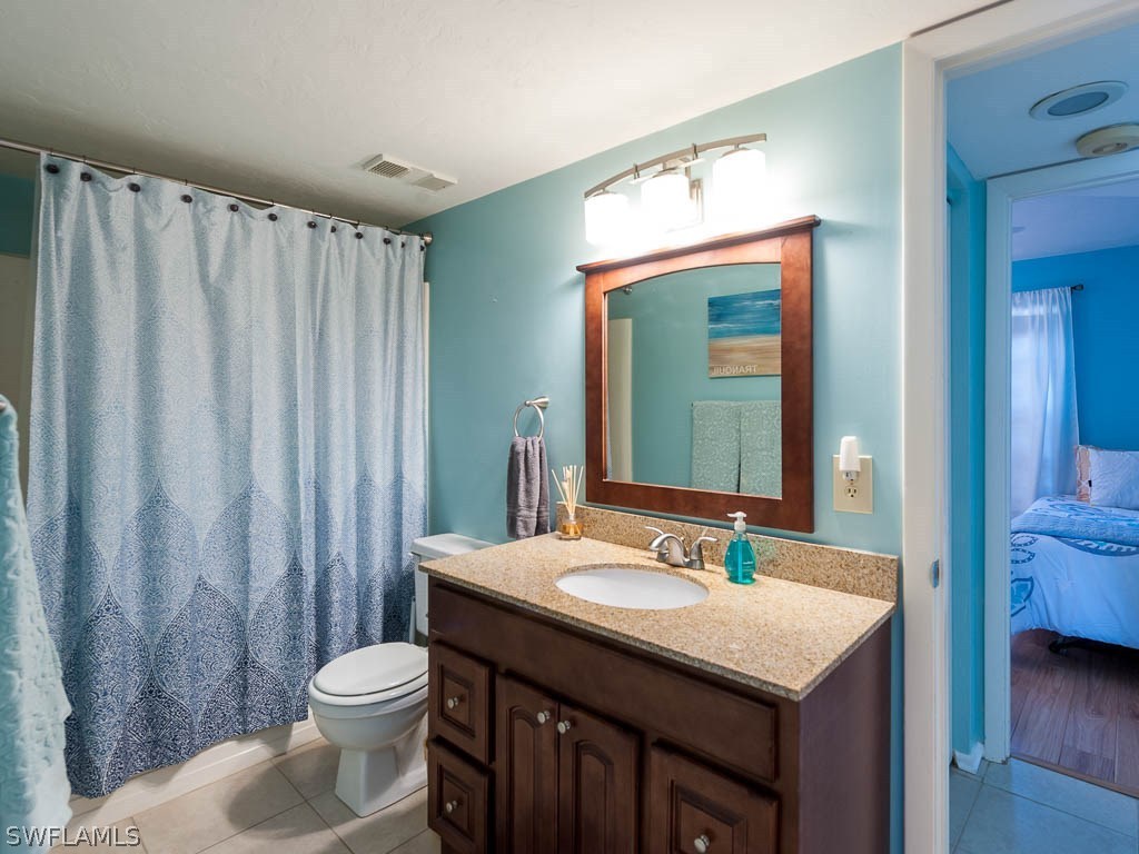16881 Davis Road, Unit 414 Fort Myers, FL 33908 - Photo 12 of 24 a bathroom with a sink a toilet and a mirror
