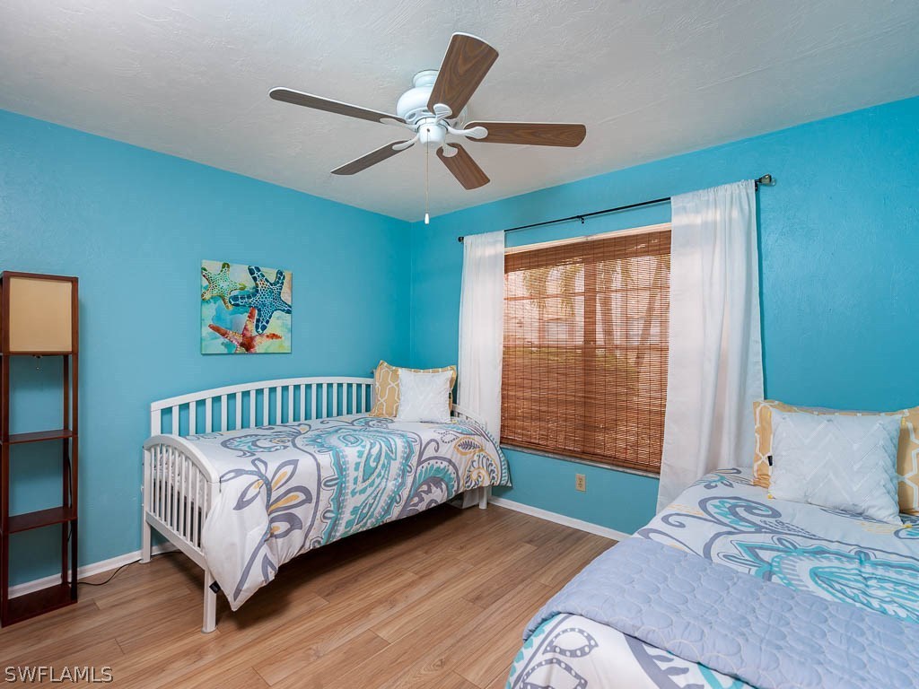 16881 Davis Road, Unit 414 Fort Myers, FL 33908 - Photo 13 of 24 a bedroom with a large bed and a window