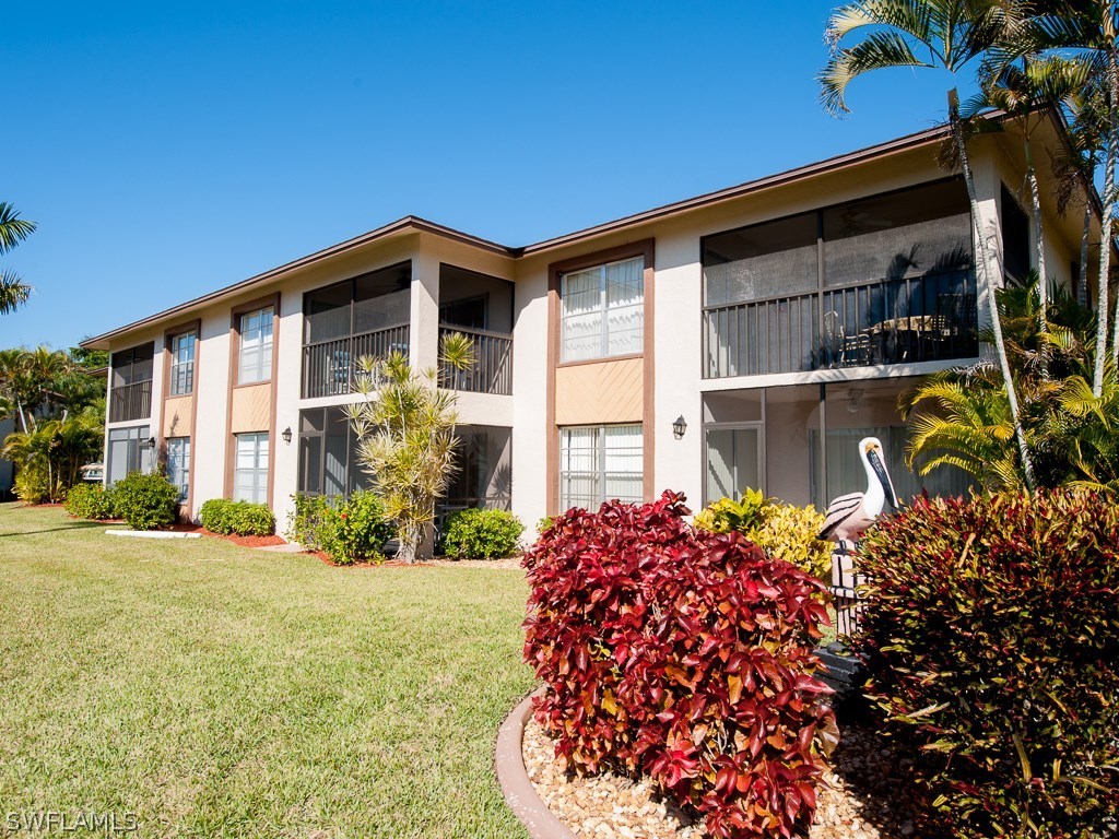 16881 Davis Road, Unit 414 Fort Myers, FL 33908 - Photo 16 of 24 a front view of a house with a yard