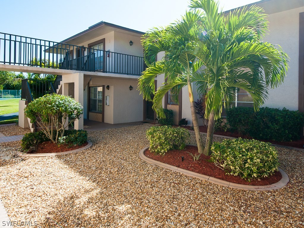 16881 Davis Road, Unit 414 Fort Myers, FL 33908 - Photo 18 of 24 a front view of a house having yard