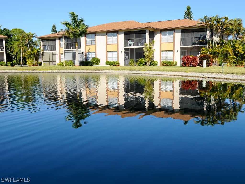 16881 Davis Road, Unit 414 Fort Myers, FL 33908 - Photo 3 of 24 front view of a house with a yard