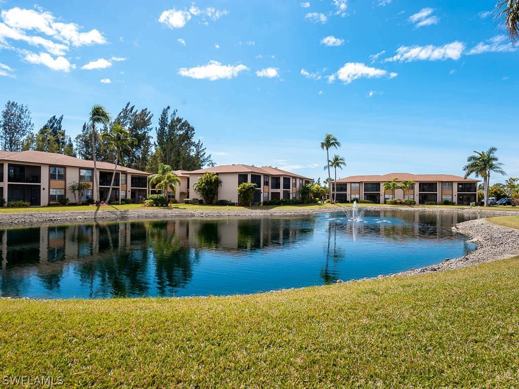16881 Davis Road, Unit 414 Fort Myers, FL 33908 - Photo 4 of 24 a view of a swimming pool and a yard
