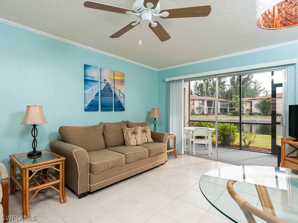 16881 Davis Road, Unit 414 Fort Myers, FL 33908 - Photo 6 of 24 a living room with furniture and a large window