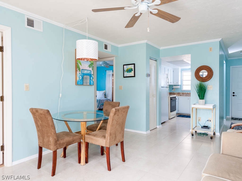 16881 Davis Road, Unit 414 Fort Myers, FL 33908 - Photo 8 of 24 a view of a livingroom and a dining room with furniture wooden floor and window