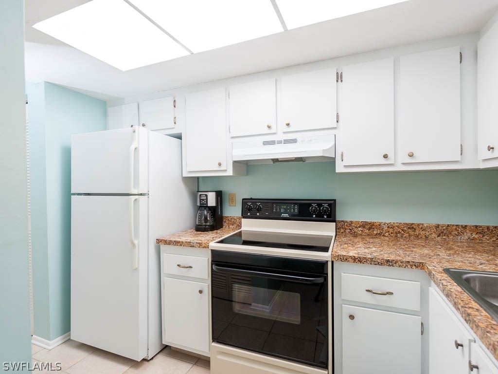 16881 Davis Road, Unit 414 Fort Myers, FL 33908 - Photo 9 of 24 a kitchen with cabinets and stainless steel appliances
