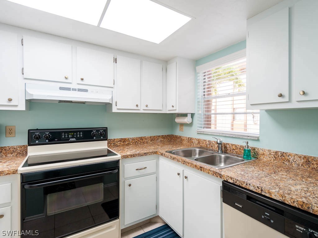 16881 Davis Road, Unit 414 Fort Myers, FL 33908 - Photo 10 of 24 a kitchen with granite countertop a sink stove and cabinets