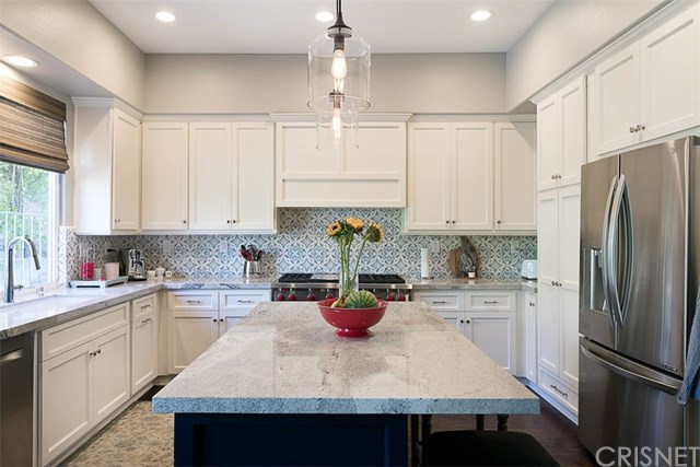 25907 Franklin Lane Stevenson Ranch, CA 91381 - Photo 12 of 58 Wow! what a kitchen check out the lights, counters, cabinetry and custom backsplash