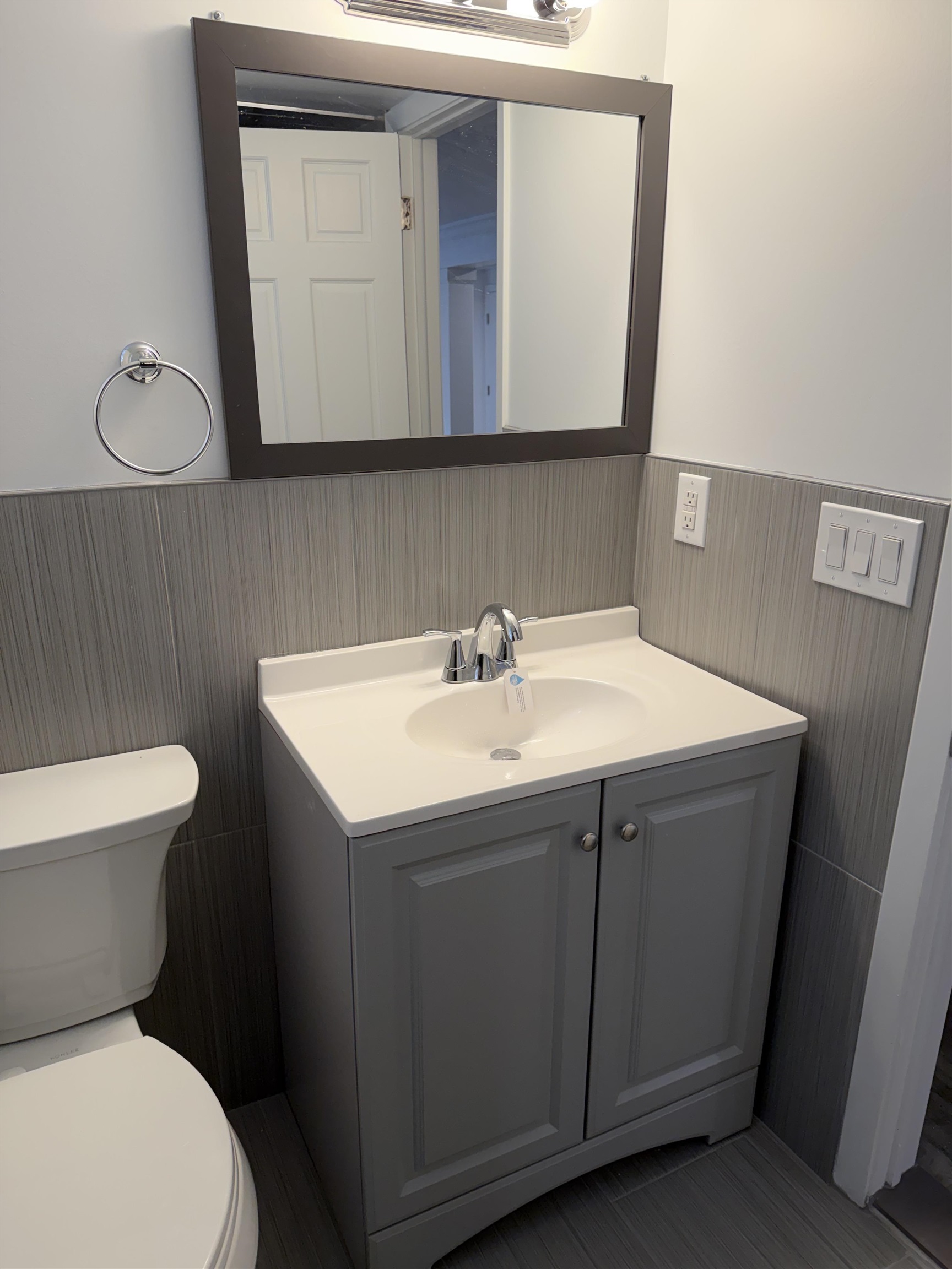290 Paterson Plank Road, Unit 1 Jersey City, NJ 07307 - Photo 6 of 17 a bathroom with a sink mirror vanity and toilet