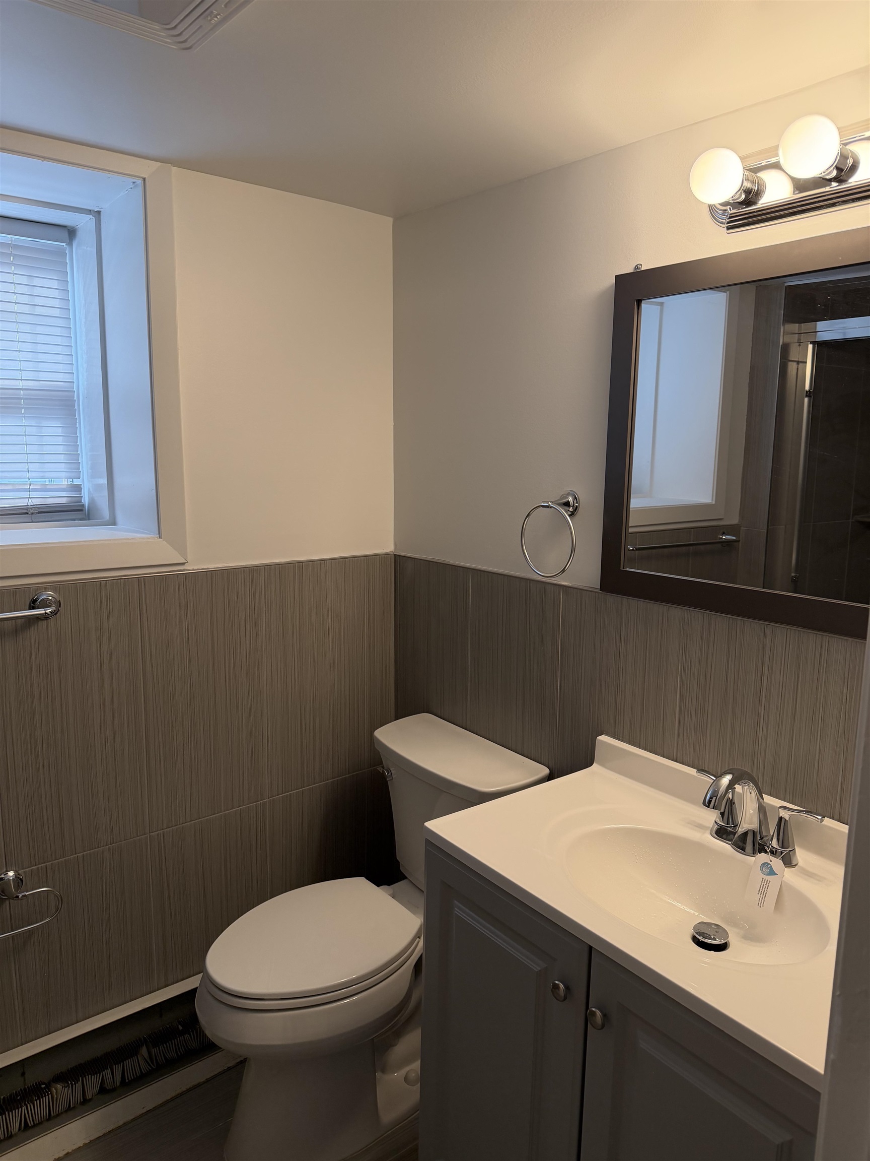 290 Paterson Plank Road, Unit 1 Jersey City, NJ 07307 - Photo 9 of 17 a bathroom with a toilet sink and mirror