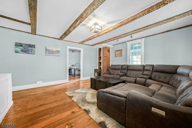 a living room with furniture and flat screen tv