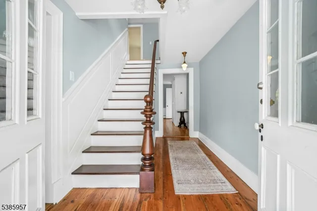 a view of entryway and hall with wooden floor