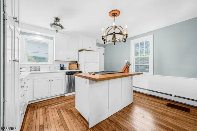 a view of a kitchen with cabinets and wooden floor