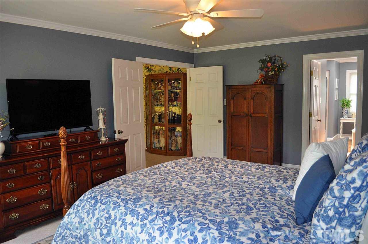 3161 Fieldstone Lane Mebane, NC 27302 - Photo 21 of 30 a bedroom with a bed and a flat screen tv in it