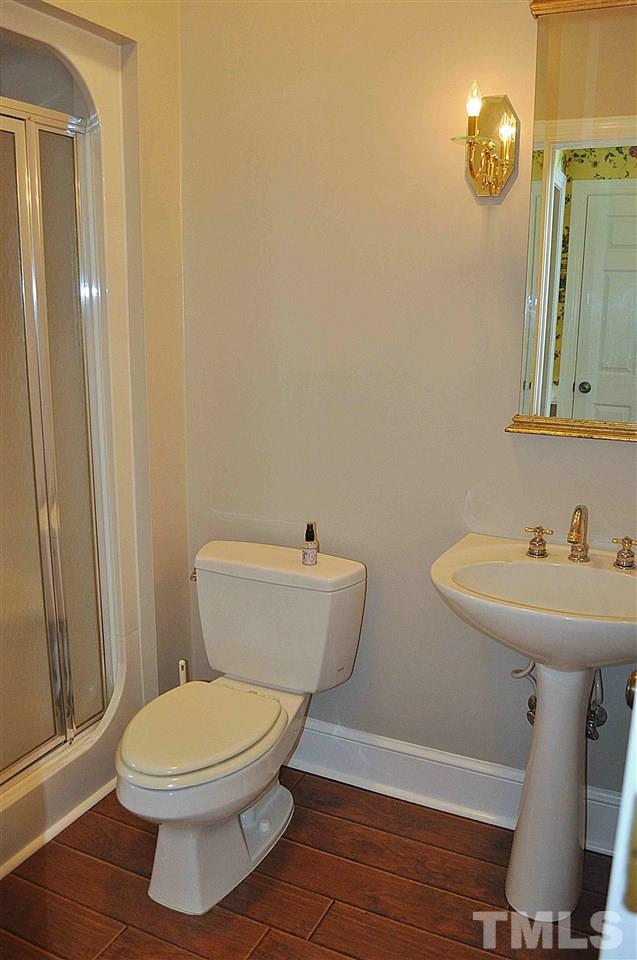 3161 Fieldstone Lane Mebane, NC 27302 - Photo 29 of 30 a bathroom with a toilet a sink and mirror