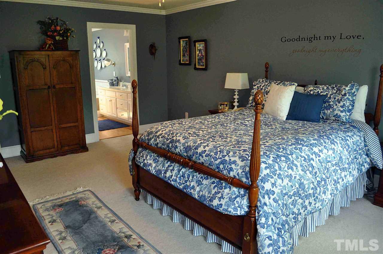 3161 Fieldstone Lane Mebane, NC 27302 - Photo 4 of 30 a bed sitting in a bedroom next to a wooden cabinet