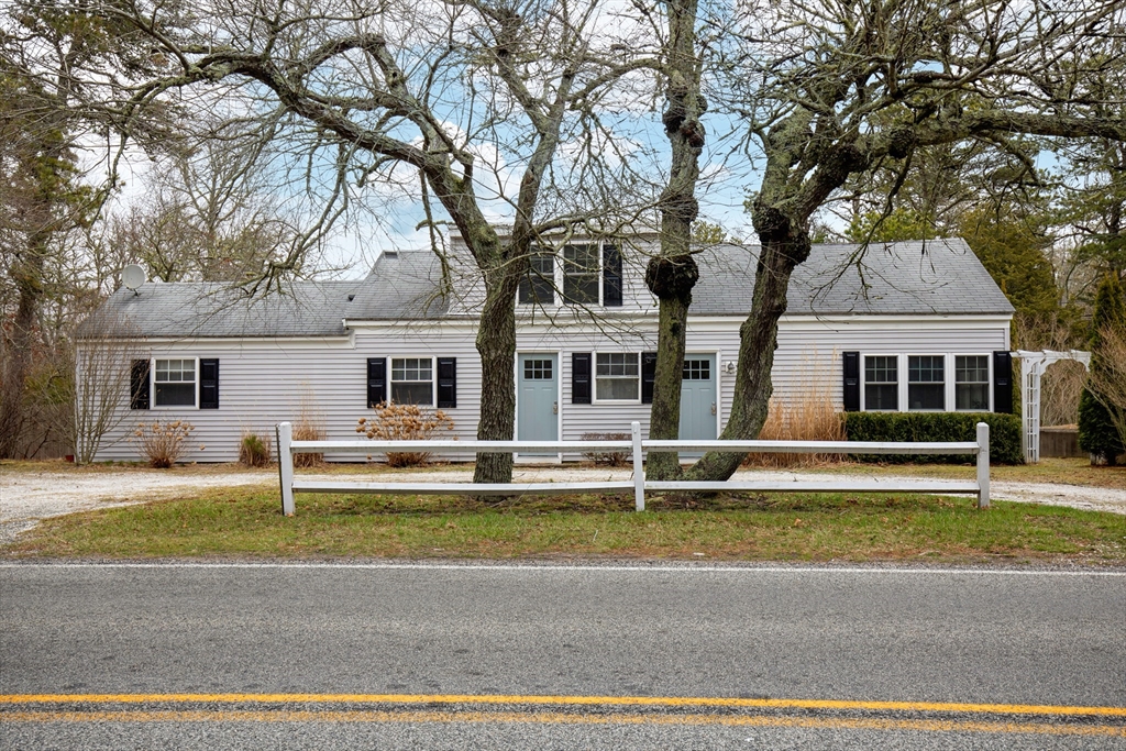 78 Upper County Road Dennis Port, MA 02639 - Photo 1 of 41 a front view of a house with a garden