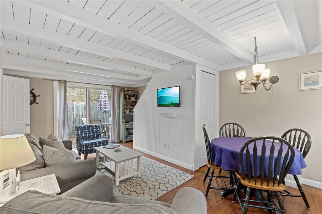 78 Upper County Road Dennis Port, MA 02639 - Photo 3 of 41 a living room with furniture a chandelier and a window