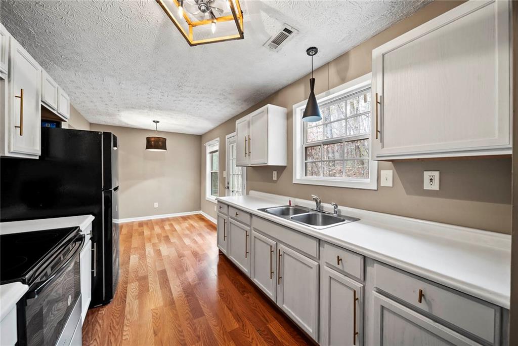 42 Crow Court Monticello, GA 31064 - Photo 11 of 33 a kitchen with a sink stove and microwave