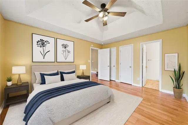 a bedroom with a large bed and a chandelier