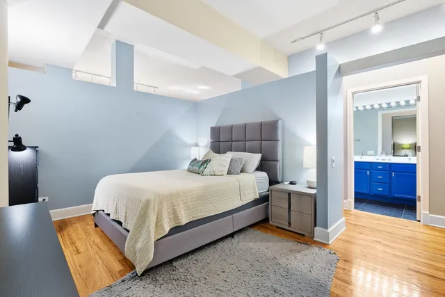 a bed room with a bed and a lamp