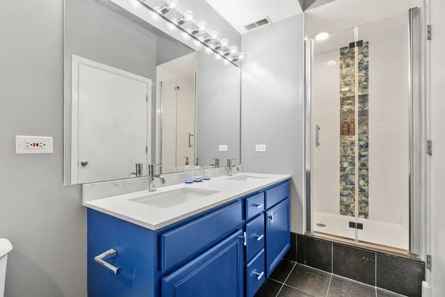 a bathroom with a shower sink and mirror