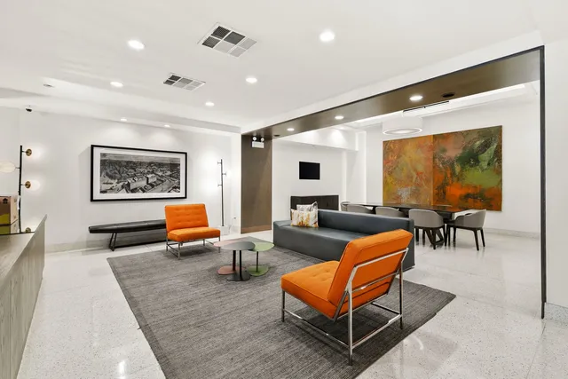 a living room with furniture kitchen view and a large window