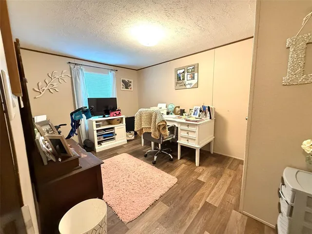 a dining room with a table chairs and a wooden floor