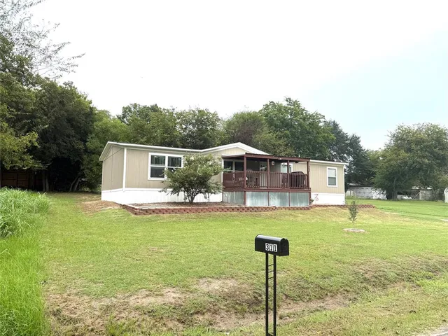a front view of a house with swimming pool having outdoor seating