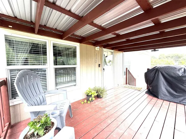 a view of a porch with furniture and a yard
