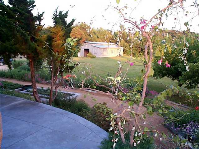 6097 Bob Daniel Road Oxford, NC 27565 - Photo 15 of 24 a view of a garden with flowers and trees