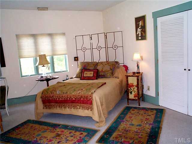 6097 Bob Daniel Road Oxford, NC 27565 - Photo 22 of 24 a bedroom with a bed and wooden floor