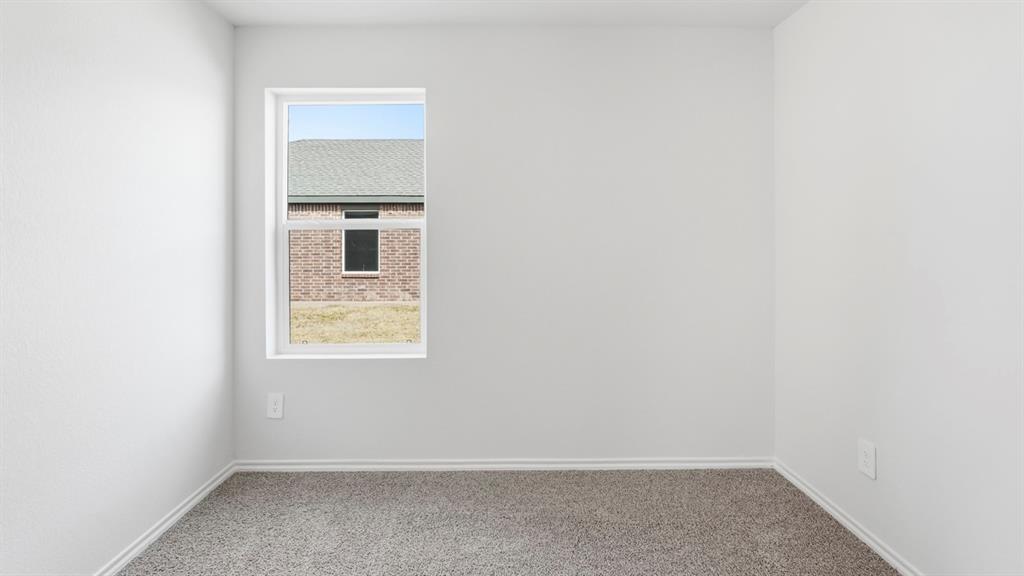 3319 Twilight Trail Forney, TX 75126 - Photo 24 of 33 Room featuring a single-pane window, light gray walls, white baseboards, and a gray carpet