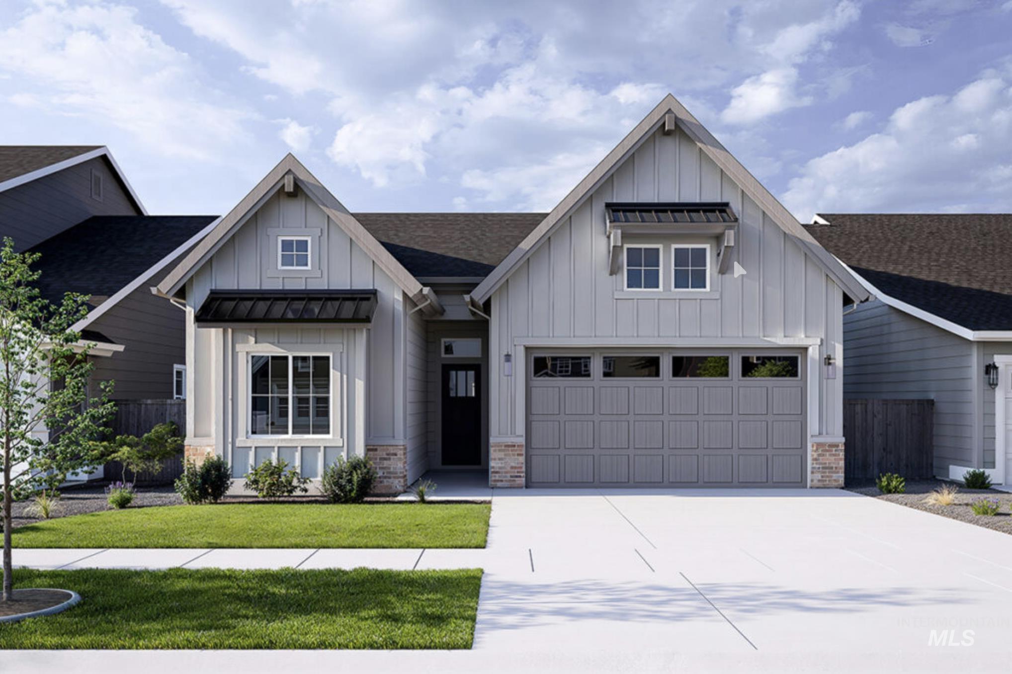 Modern inspired farmhouse with board and batten siding, a standing seam roof, roof with shingles, and a metal roof