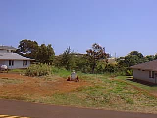 4817 Ohu Road Kapaa, HI 96746 - Photo 6 of 6 a backyard of a house with lots of green space and lake view in back