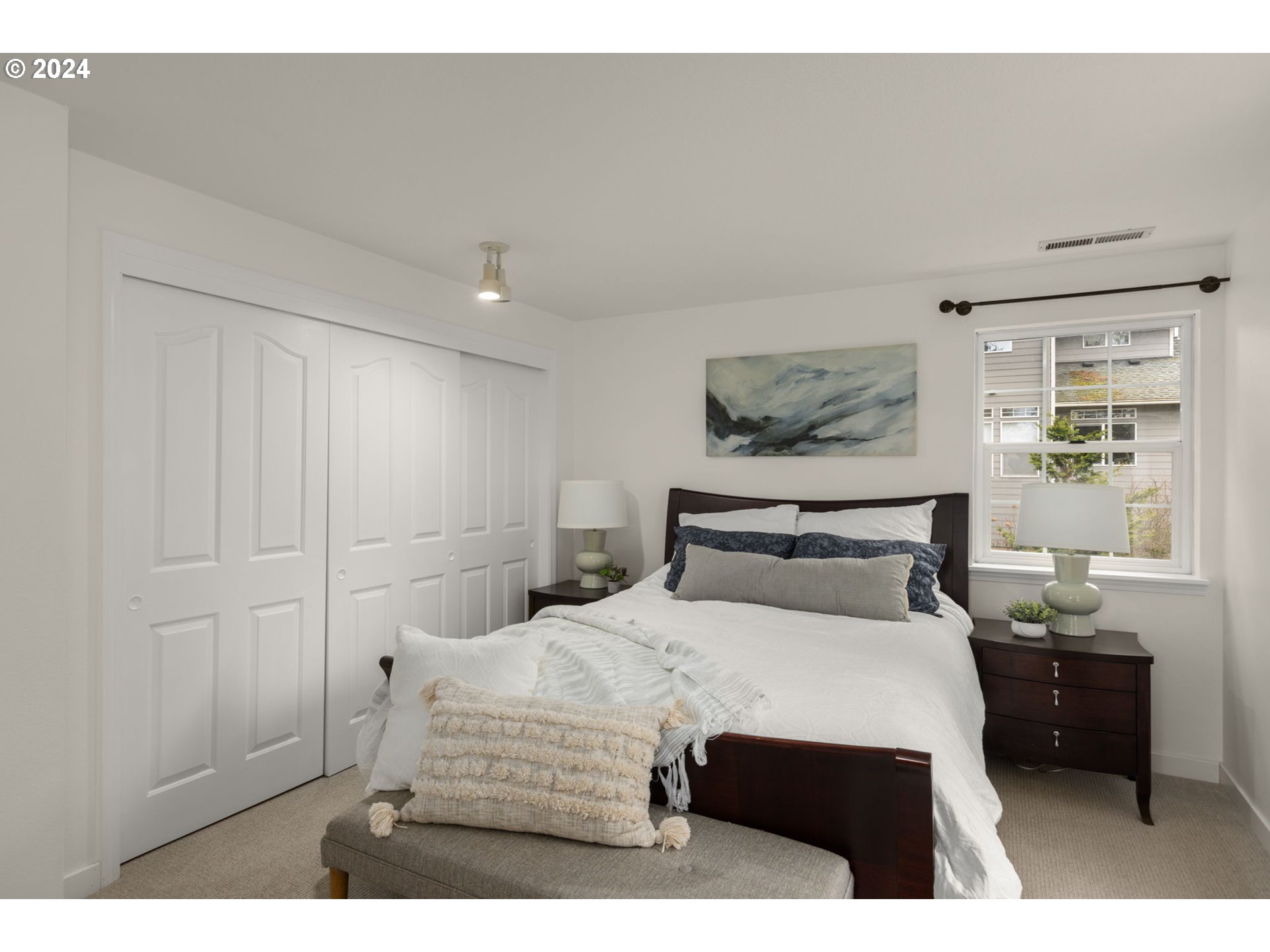 3625 Southwest Vacuna Street Portland, OR 97219 - Photo 16 of 27 a bedroom with a bed and a night stand