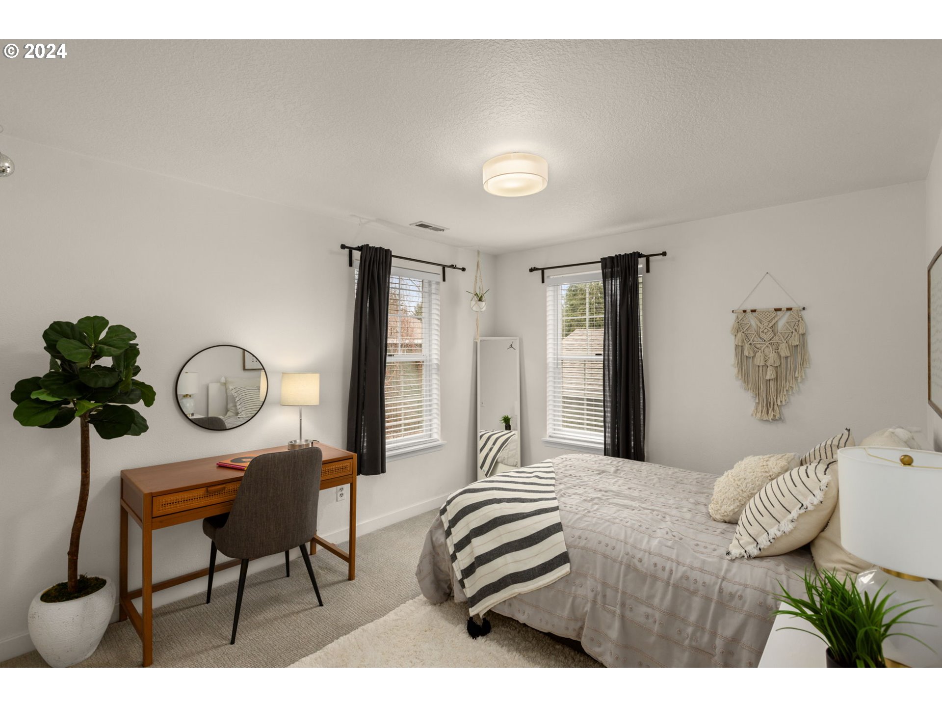 3625 Southwest Vacuna Street Portland, OR 97219 - Photo 22 of 27 a bedroom with furniture and a chandelier