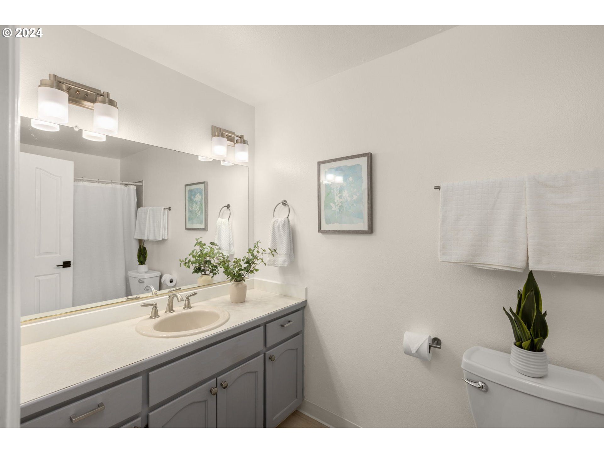 3625 Southwest Vacuna Street Portland, OR 97219 - Photo 24 of 27 a bathroom with a sink and a mirror