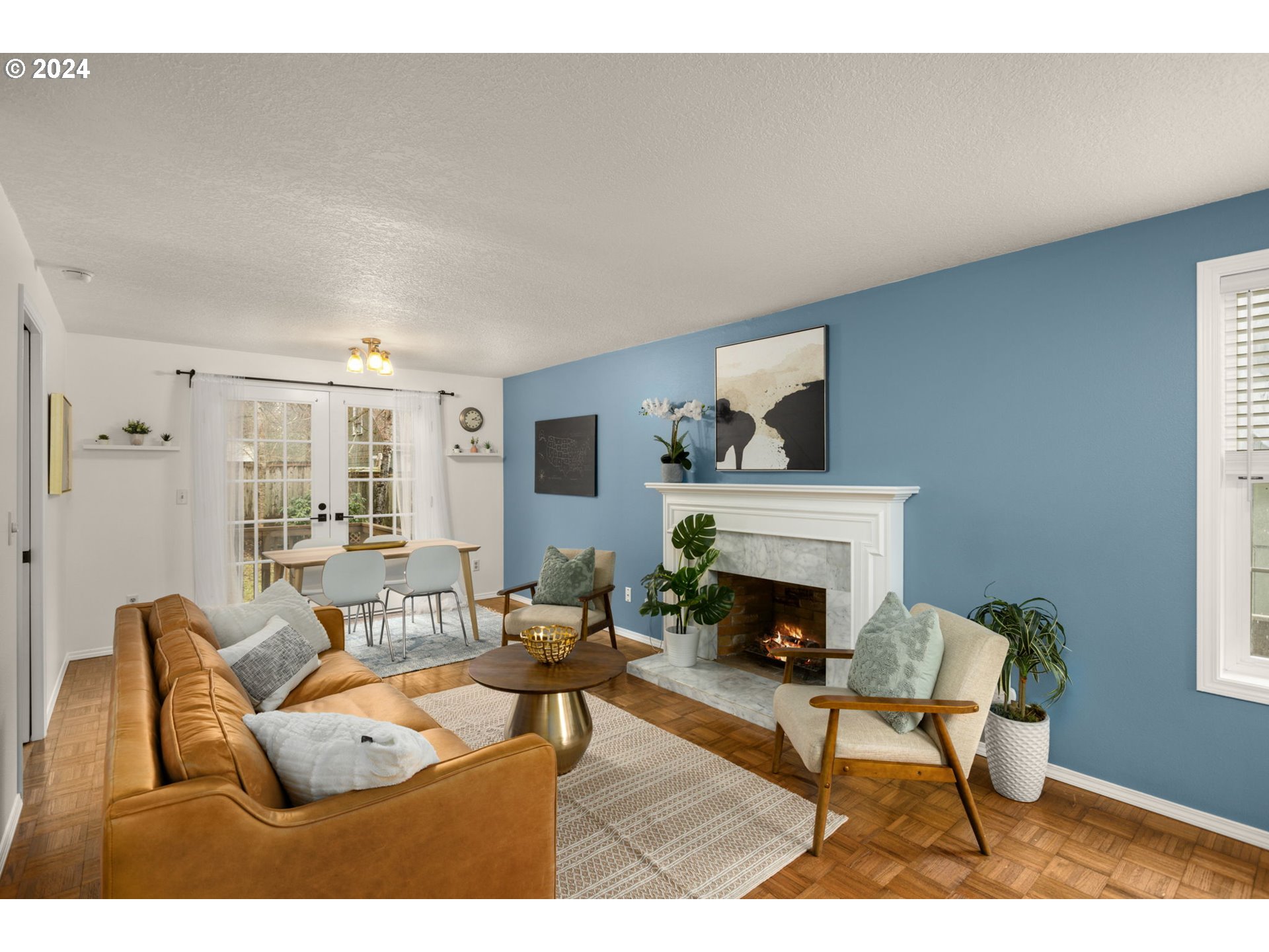 3625 Southwest Vacuna Street Portland, OR 97219 - Photo 3 of 27 a living room with furniture and a fireplace