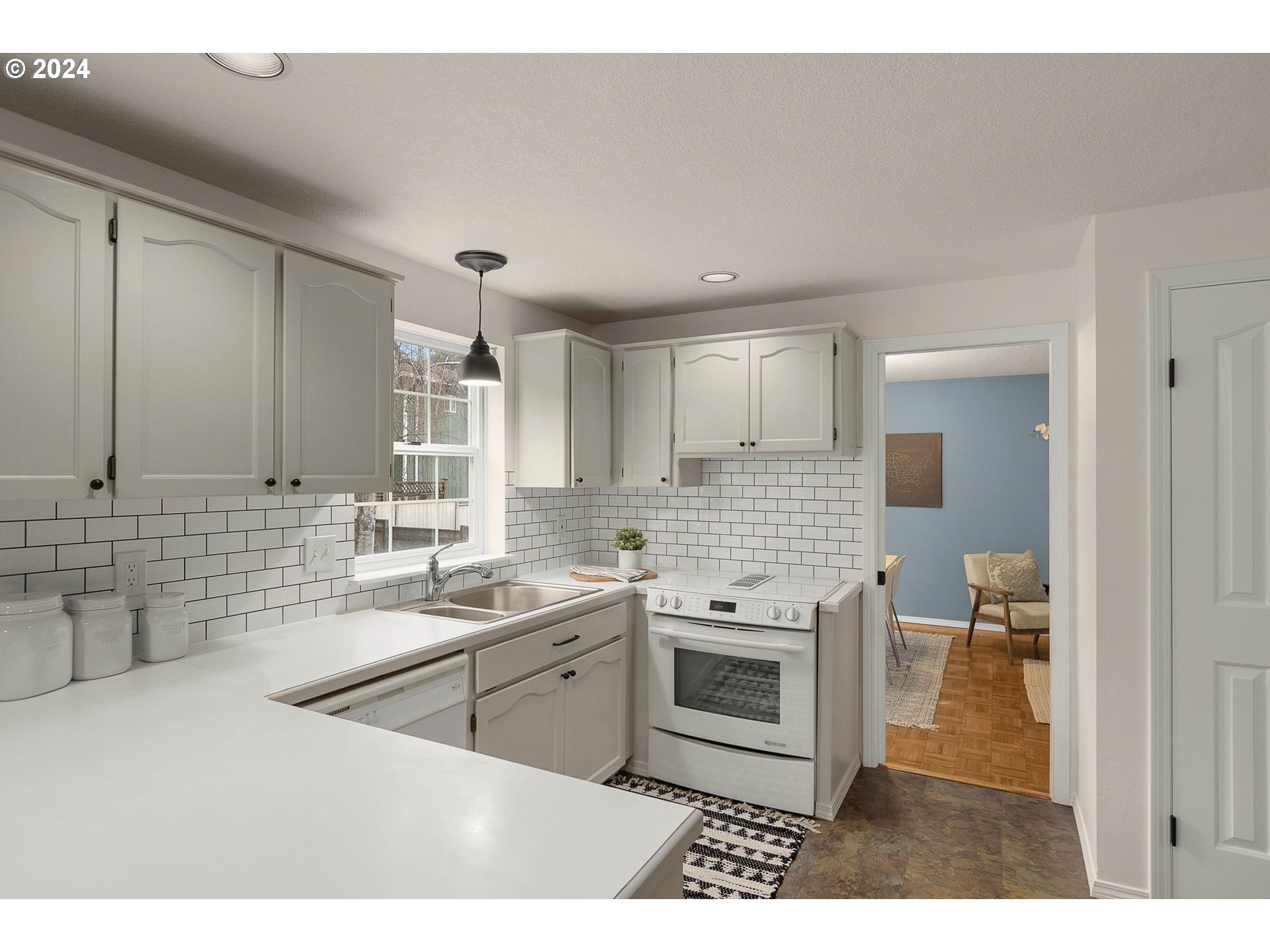 3625 Southwest Vacuna Street Portland, OR 97219 - Photo 7 of 27 a kitchen with a sink stove and cabinets