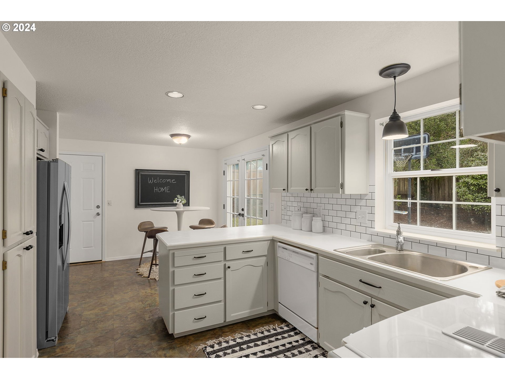 3625 Southwest Vacuna Street Portland, OR 97219 - Photo 8 of 27 a kitchen with a sink and a refrigerator
