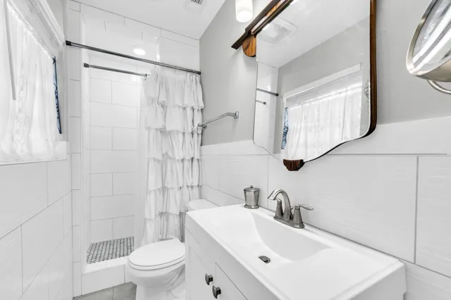 a bathroom with a sink toilet and shower