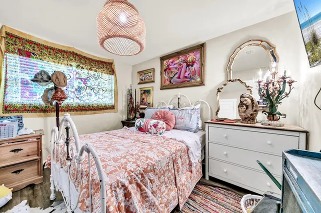 a bedroom with a bed and dresser